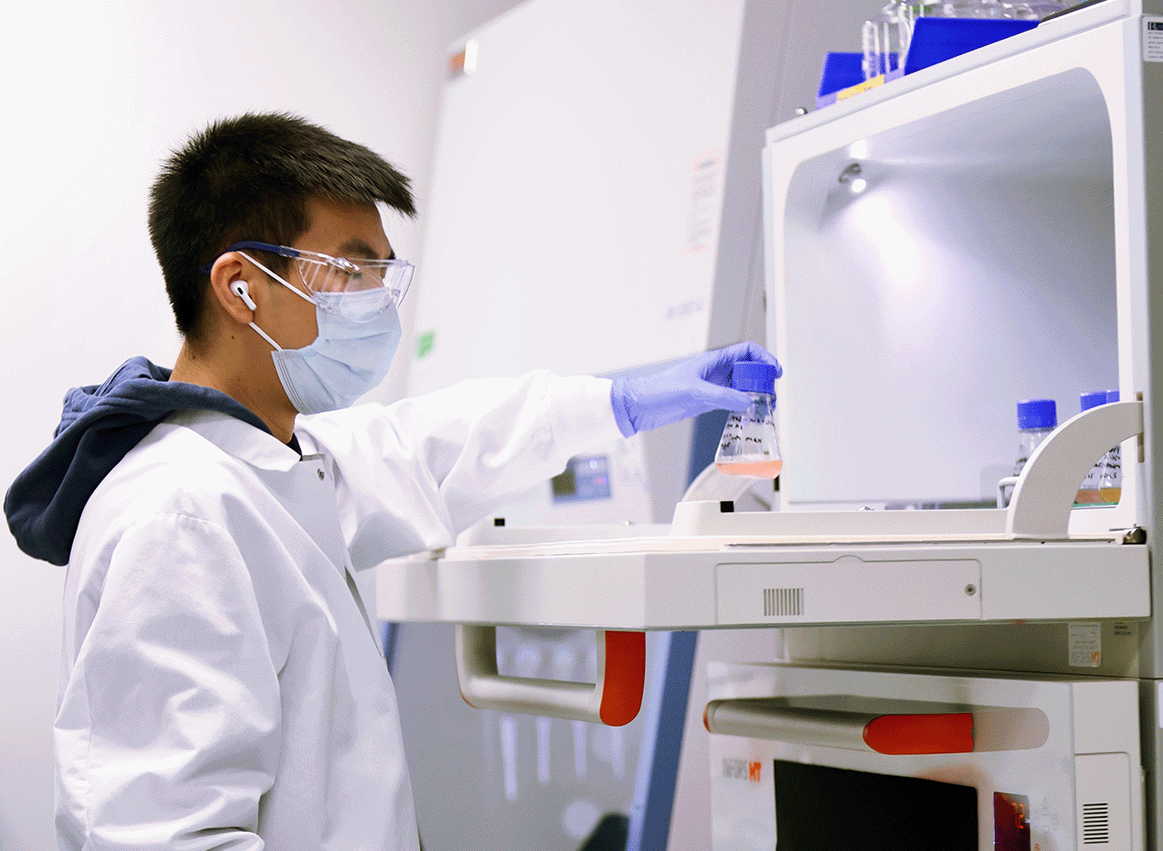 Scientist taking flask out from shaker_cropped